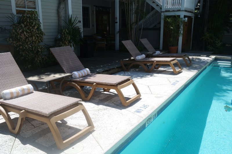 Pool deck with modern lounge chairs and rolled towels