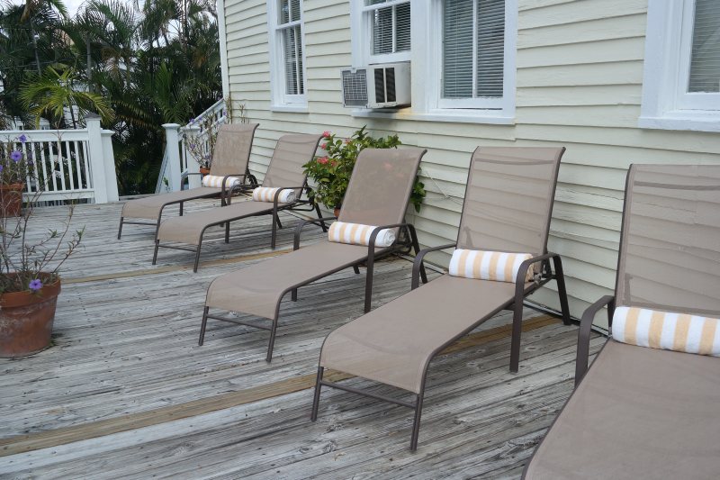 Rooftop sundeck with lounge chairs and rolled towels