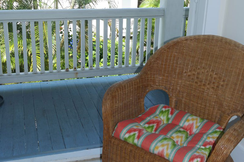 Balcony room with private outdoor seating overlooking tropical courtyard